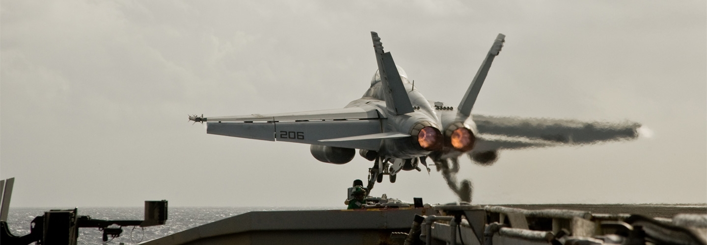 jet taking off of aircraft carrier